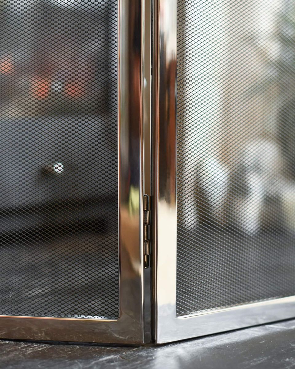 Close-Up of Polished Steel "Strandly Grange" Iron Fire Guard 