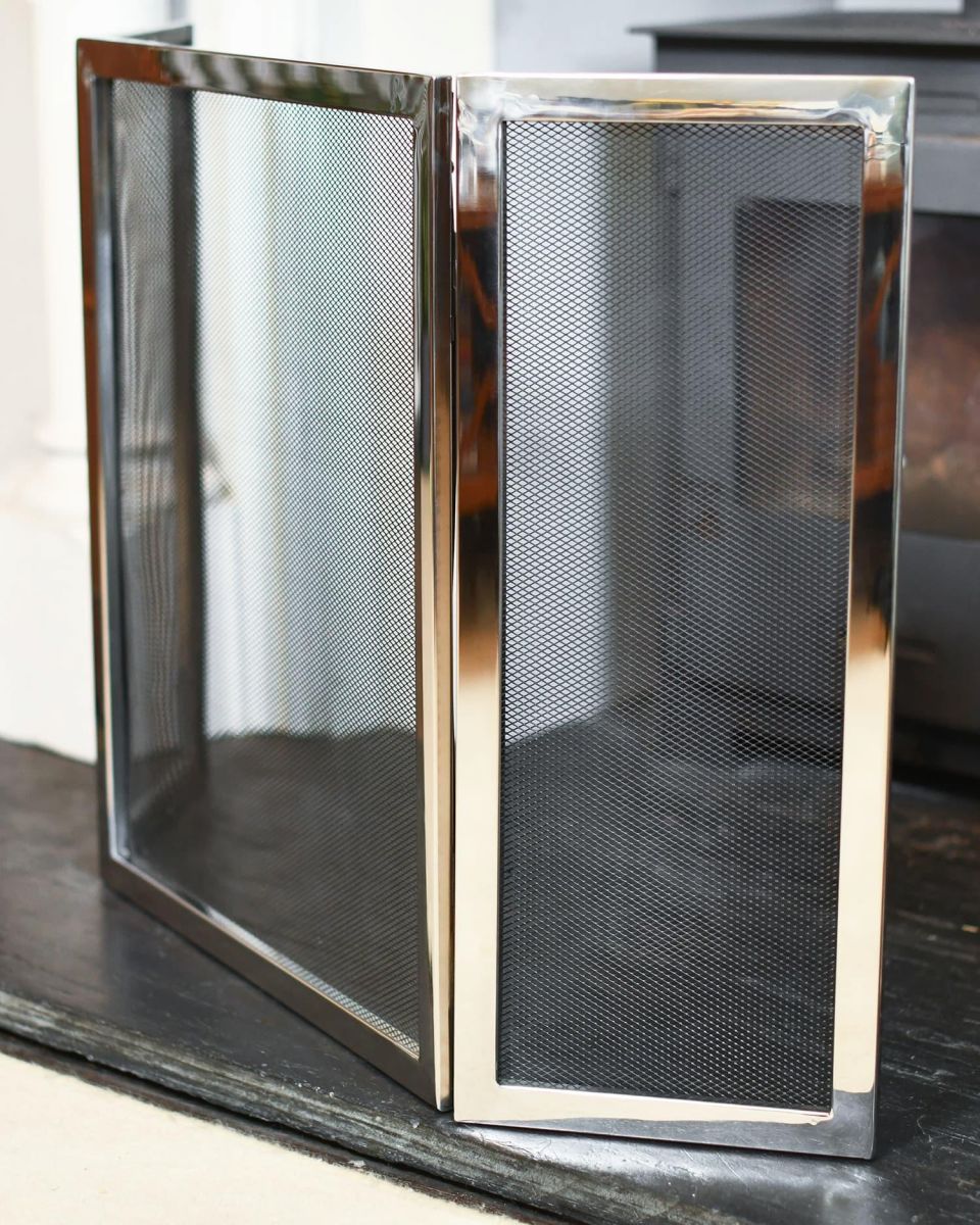 Close-Up of "Strandly Grange" Polished Steel and Iron Fire Guard in Situ