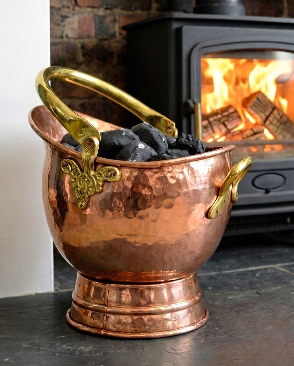The 41cm"Windsor" Coal Bucket in a Copper Effect Finish Displayed on a Black Stone Fireplace - Digital Illustration