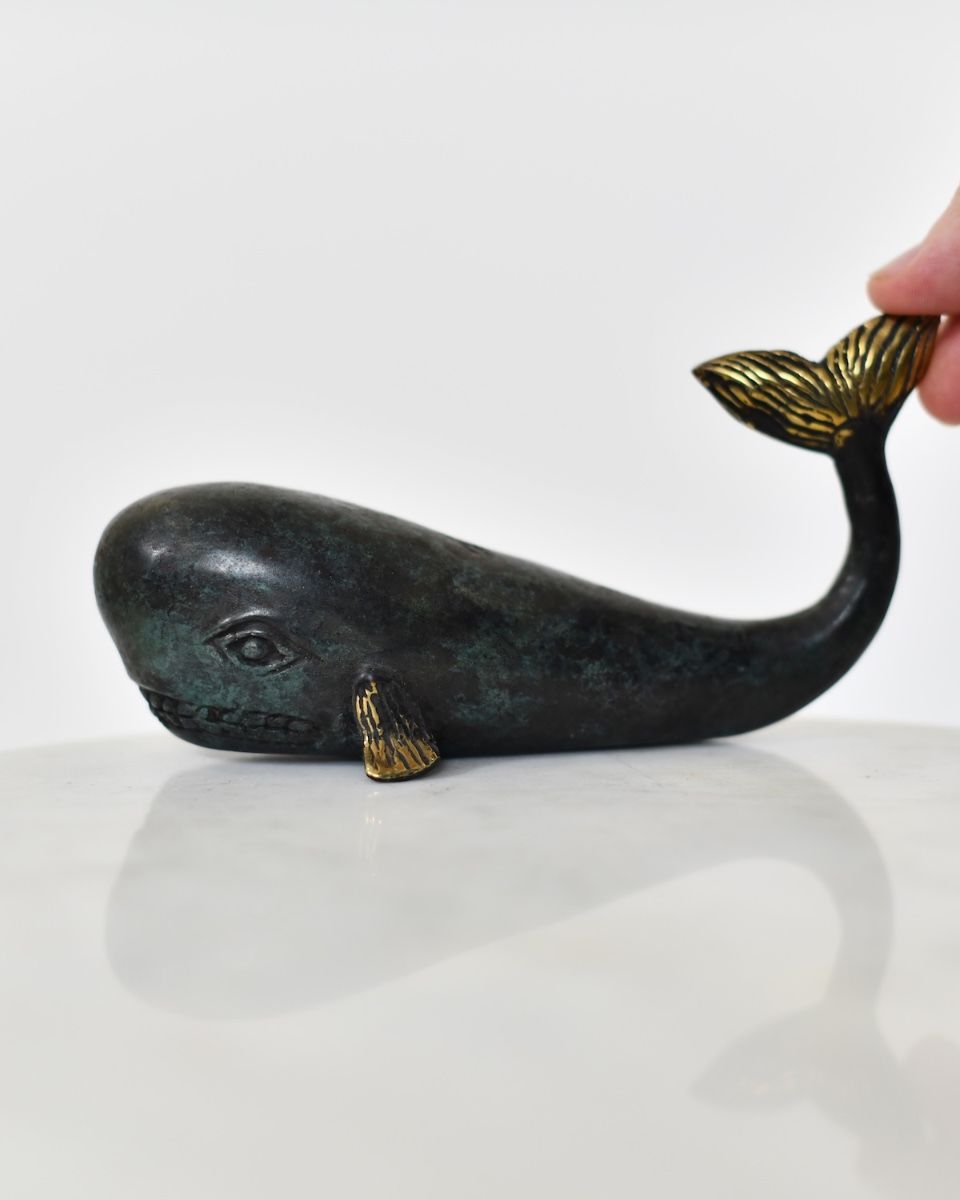 "Abyssal Voyager" Whale Ornament in Cast Brass with hand in shot for scale