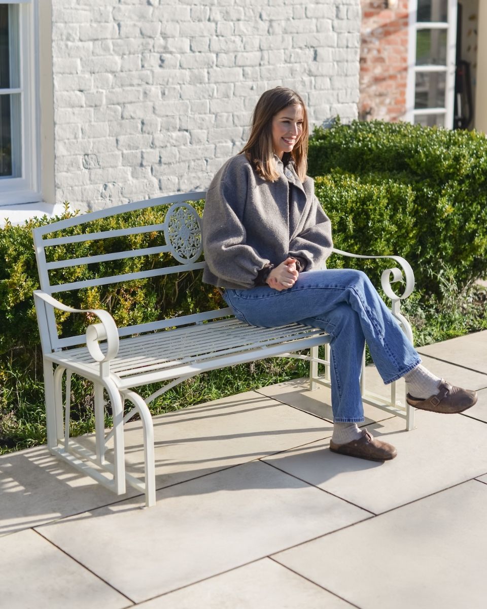"Arcadia" Garden Rocking Bench Wrought Iron - Cream with lady sat on bench