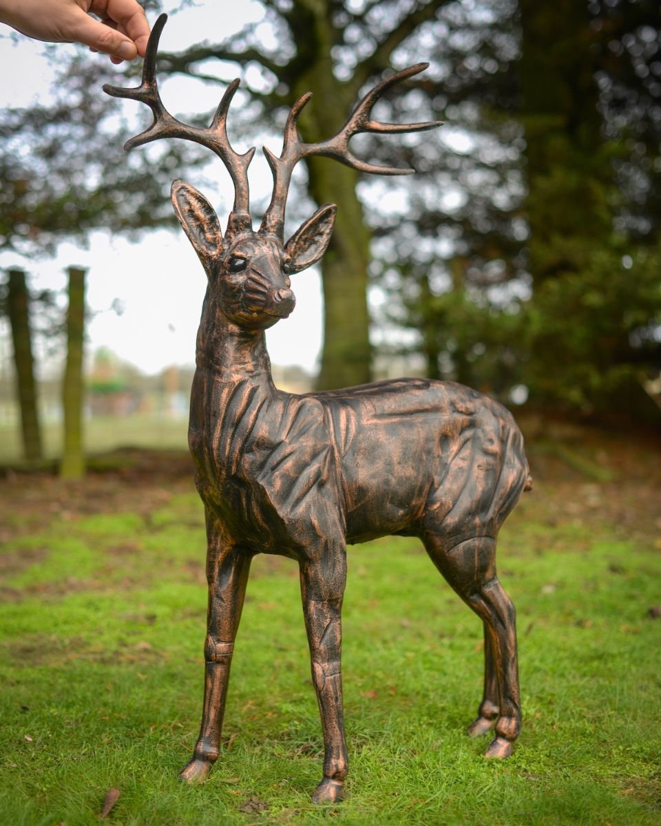 "Ash" the Cast Aluminium Observant Stag Garden Sculpture with hand in shot for scale