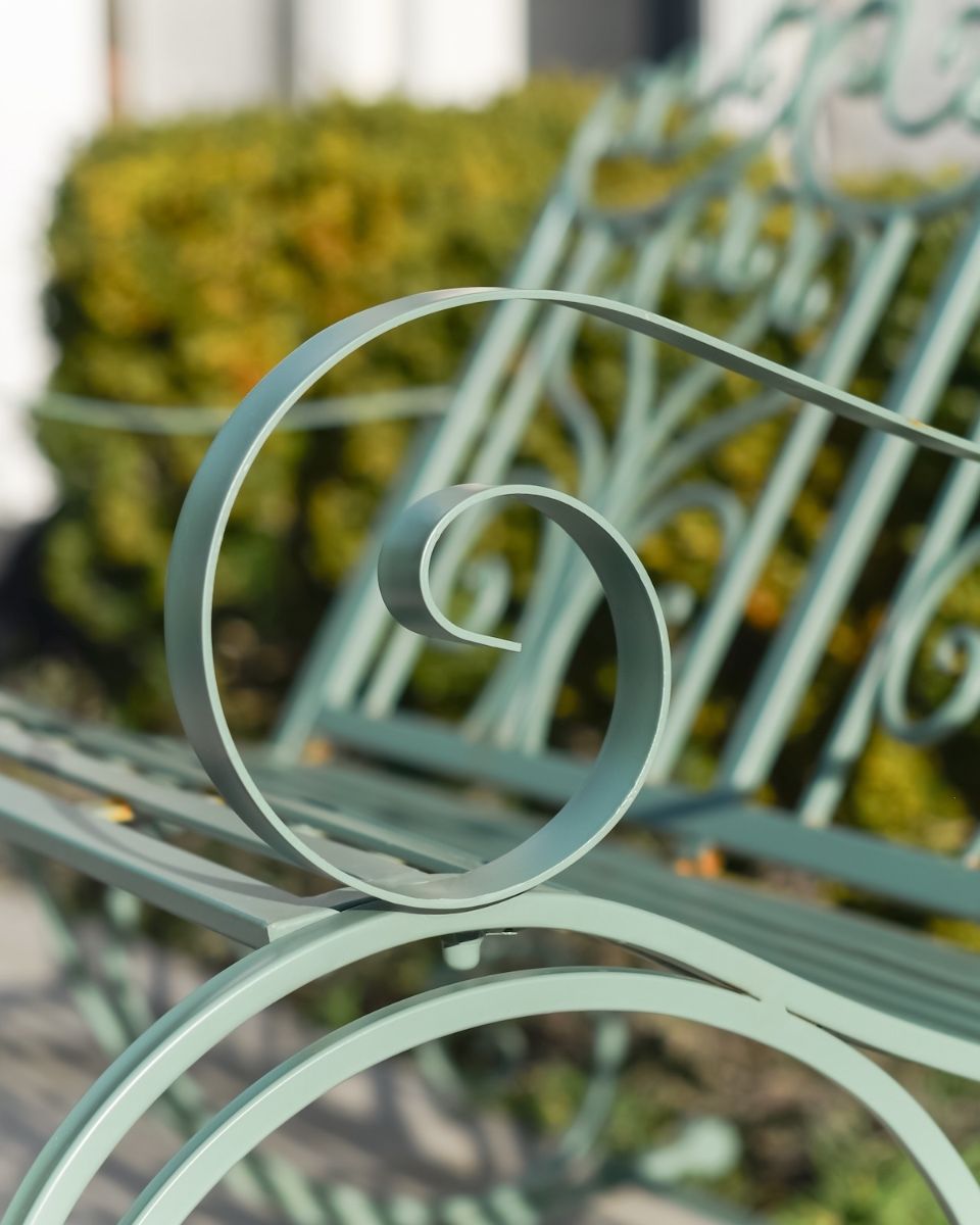 "Belvedere" Garden Rocking Bench Wrought Iron - Sage close up of arm rest