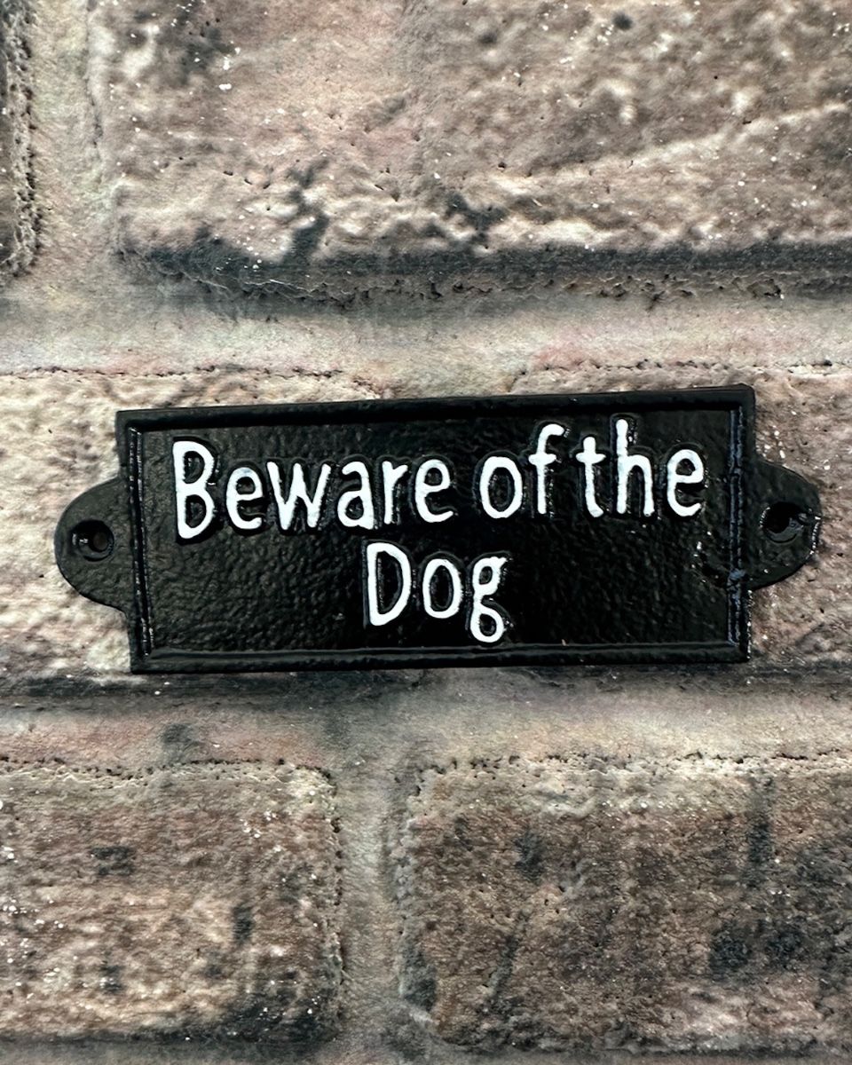 "Beware of the Dog" Traditional Cast Iron Wall Sign mounted on a brick wall