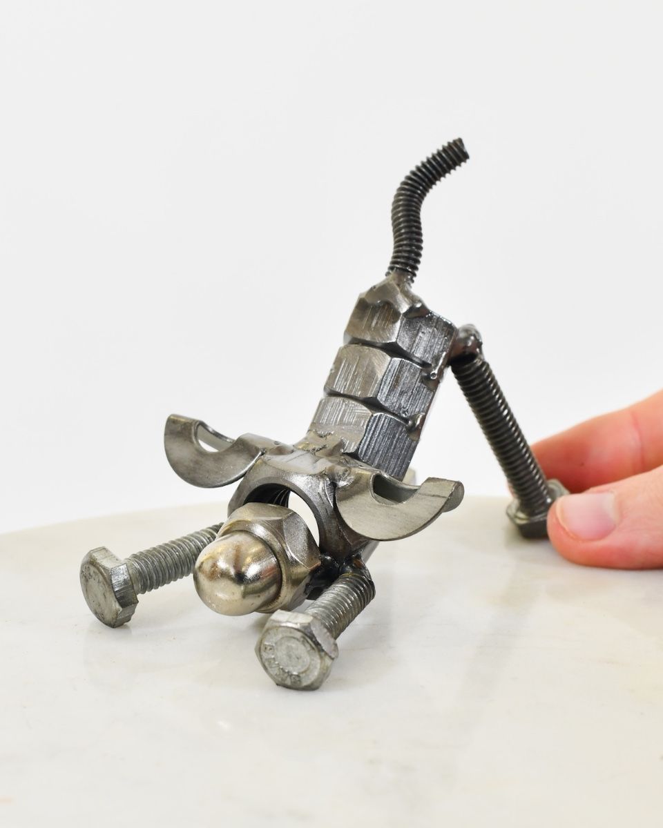 "Bolt" Stretching Puppy UpCycled Home Ornament with hand in shot for scale