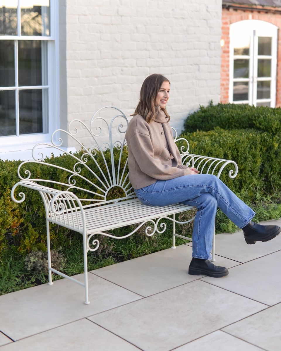 ‘Bordeaux" Wrought Iron Garden Bench - Cream with lady sat on bench