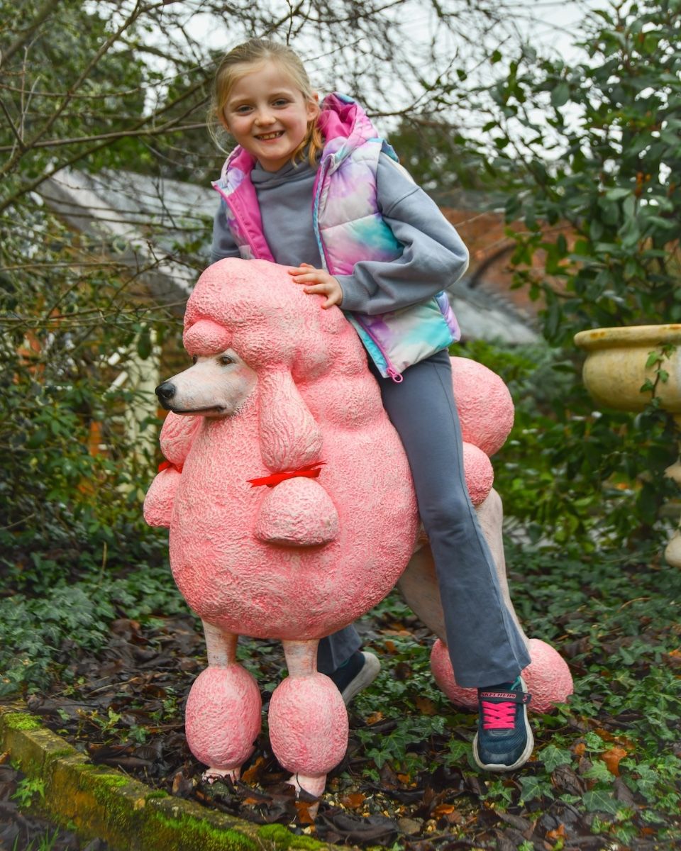 ‘Candyfloss’ the Poodle Fibreglass Garden Sculpture with child sat on top smiling