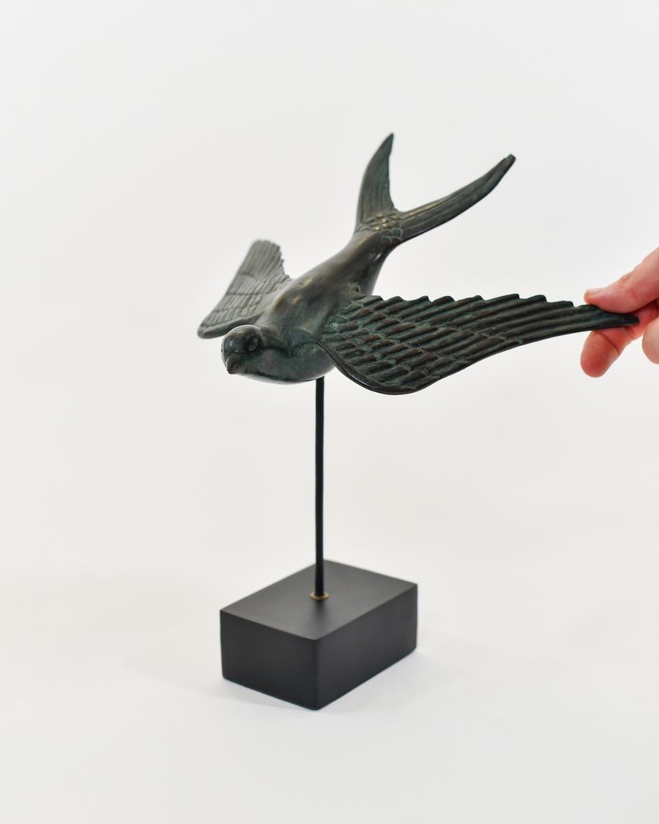 "Celestial Soloist" Cast Brass Bird Ornament with hand in shot for scale