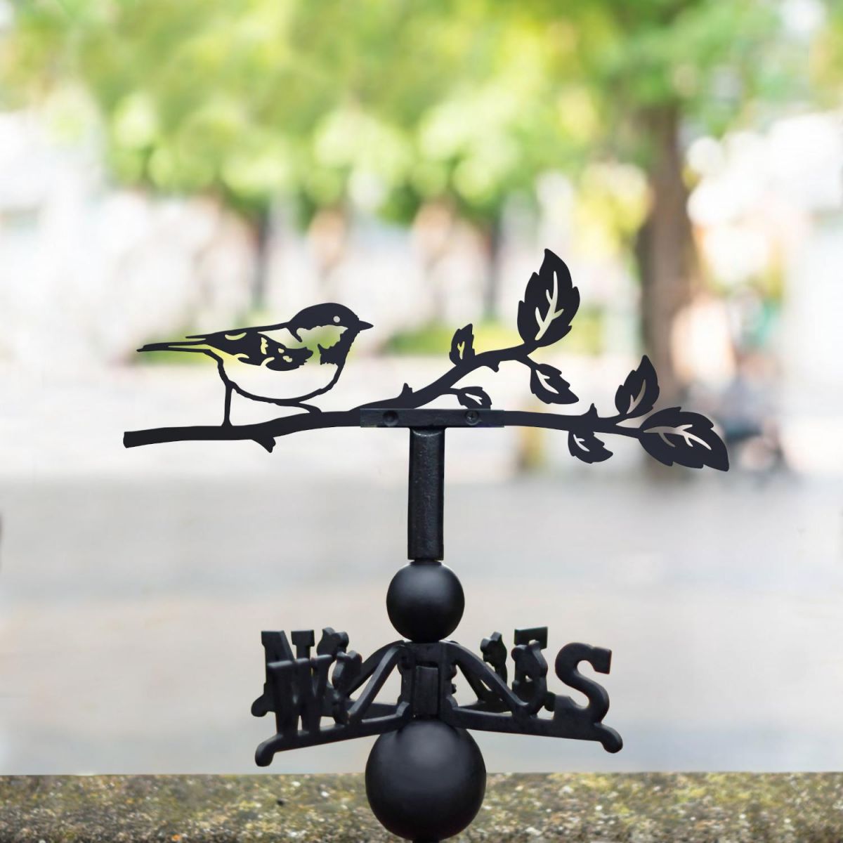 Coal tit weathervane in the park
