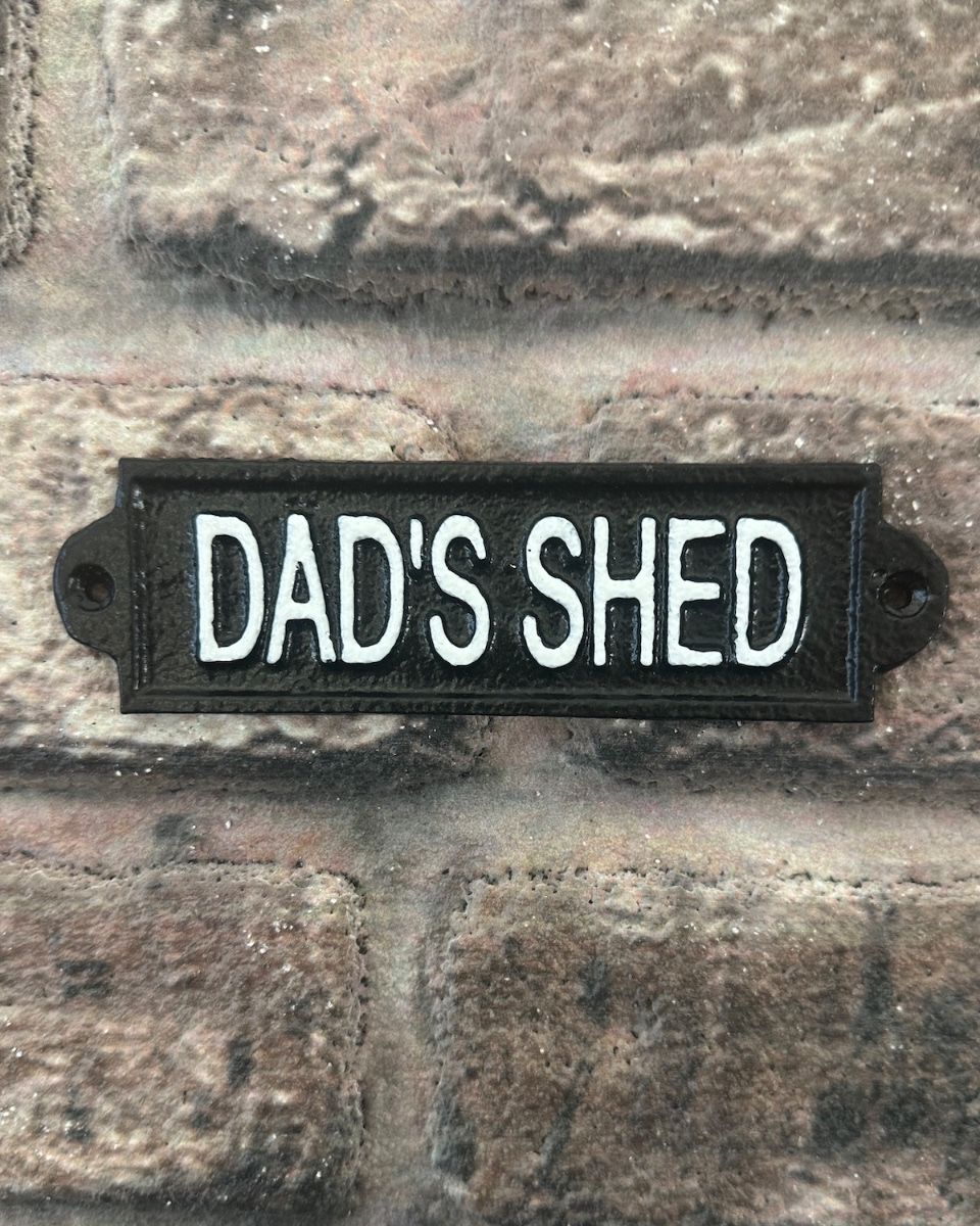 "Dad"s Shed" Traditional Cast Iron Wall Sign mounted on a brick wall