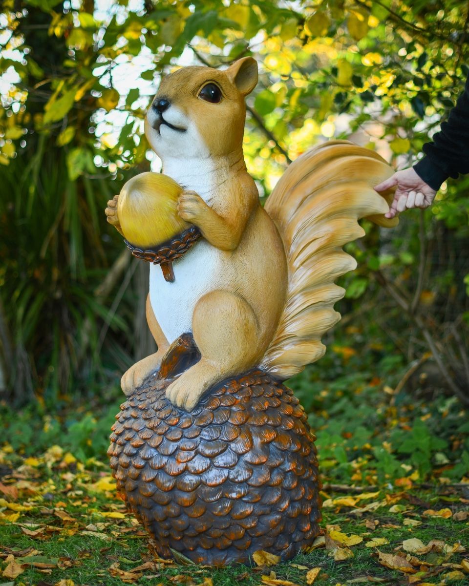 "Dash" the Handpainted Fibreglass Squirrel Garden Sculpture with hand in shot for scale