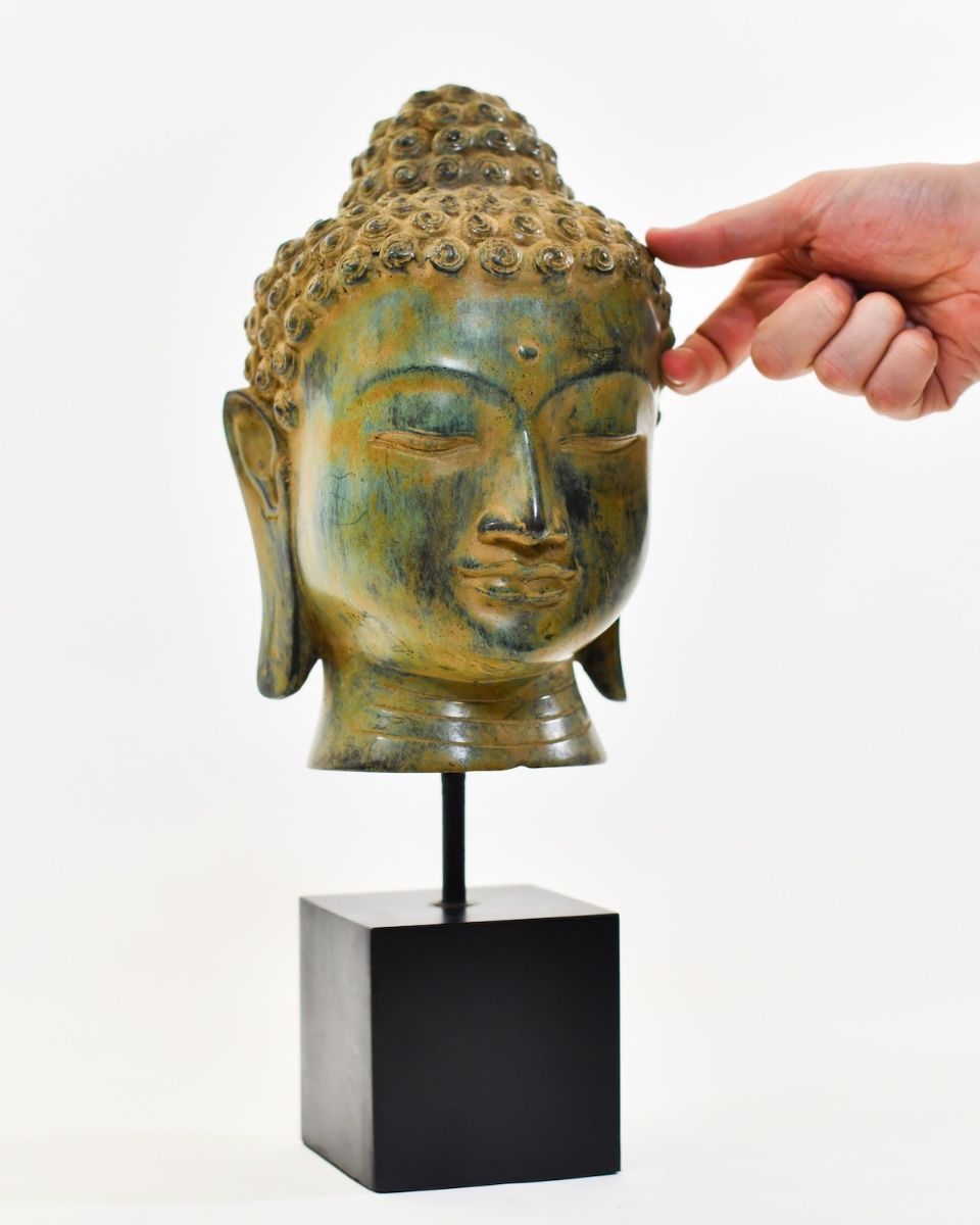 "Emerald Serenity" Buddha Head Ornament in Cast Brass with hand in shot for scale