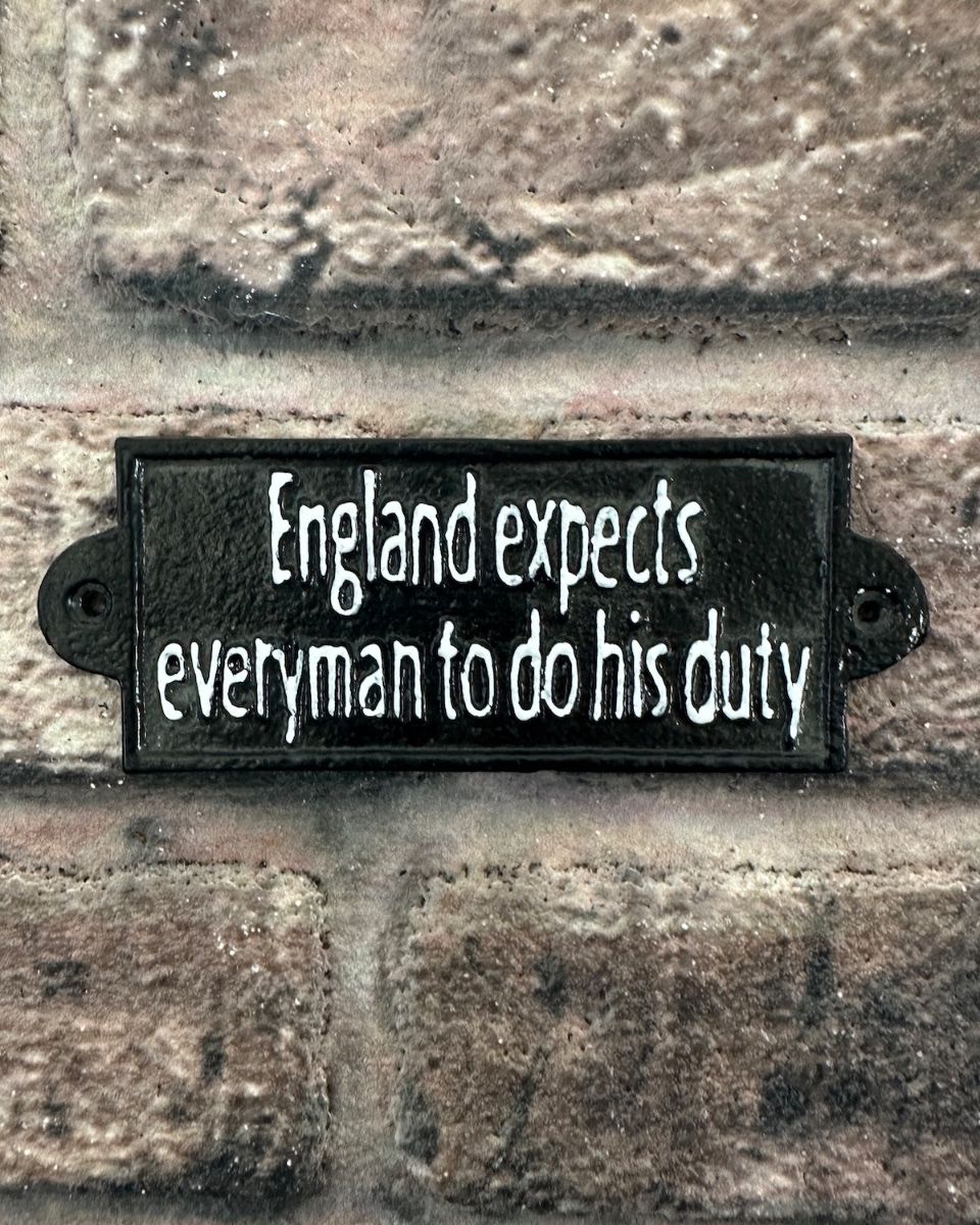 "England Expects Everyman to do their Duty" Traditional Cast Iron Wall Sign mounted on brick wall