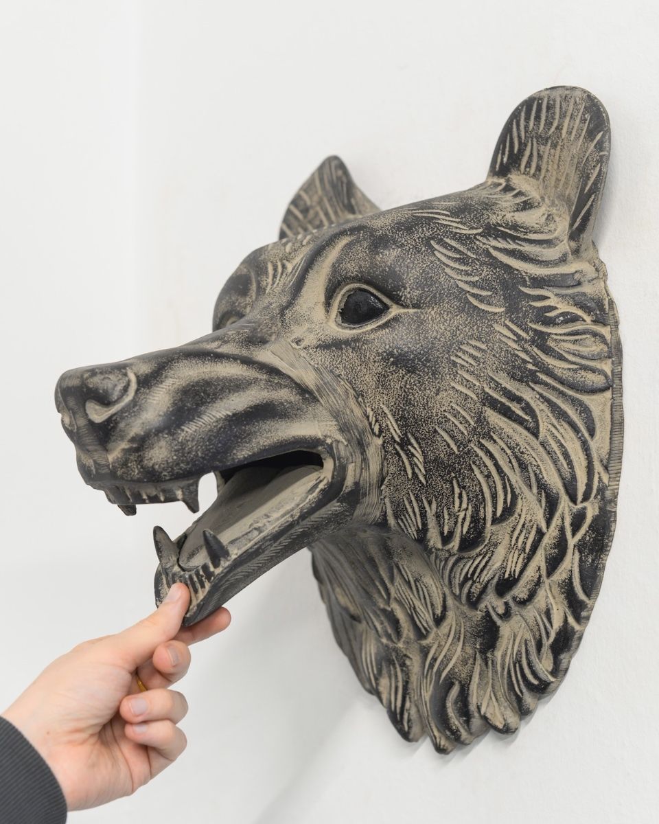 "Flint" the Bear Cast Aluminium Wall Art with hand in shot for scale