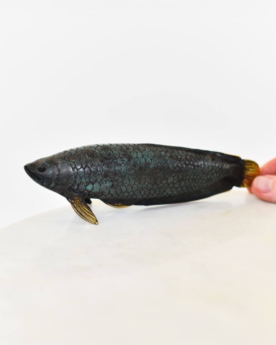 "Gilded Current" Cast Brass Fish Ornament with hand in shot for scale