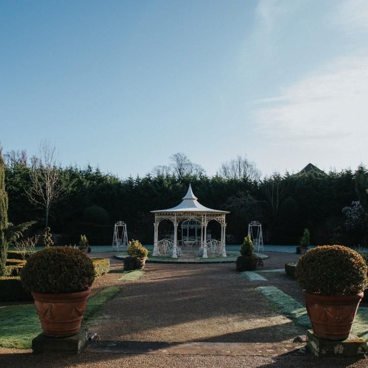"Lady Leticia Dream Carousel" Bandstand Pavilion in Cream at the End of a Garden - Manor By The Lake  "Lady Leticia Dream Carousel" Bandstand Pavilion in Cream at the End of a Garden - Manor By The Lake