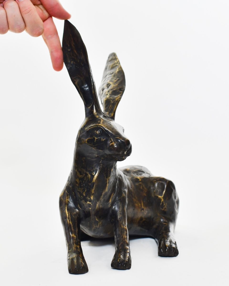 "Meadow Matriarch" Cast Brass Sitting Hare Sculpture with hand in shot for scale