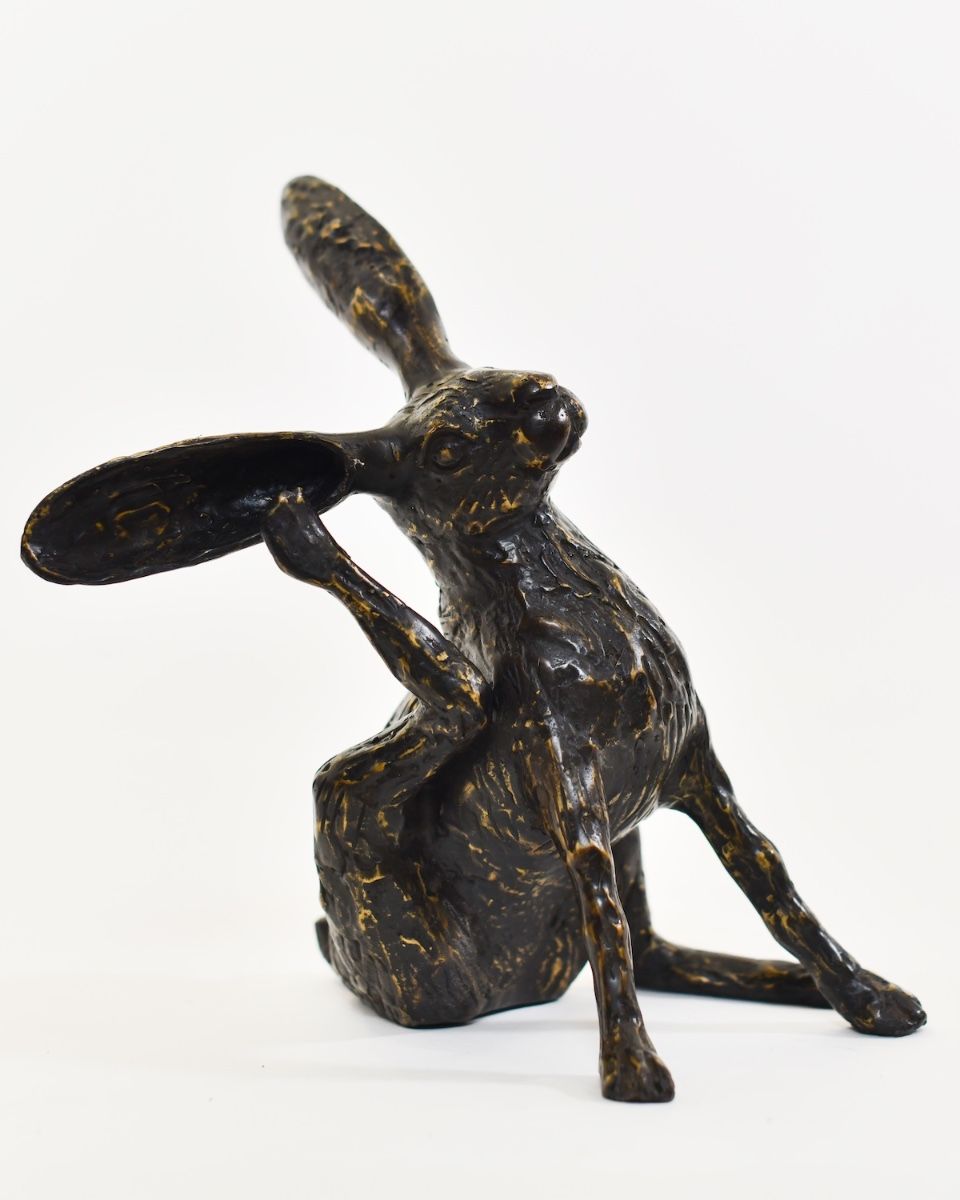 "Meadow Muse" Cast Brass Grooming Hare Sculpture angled view of hare