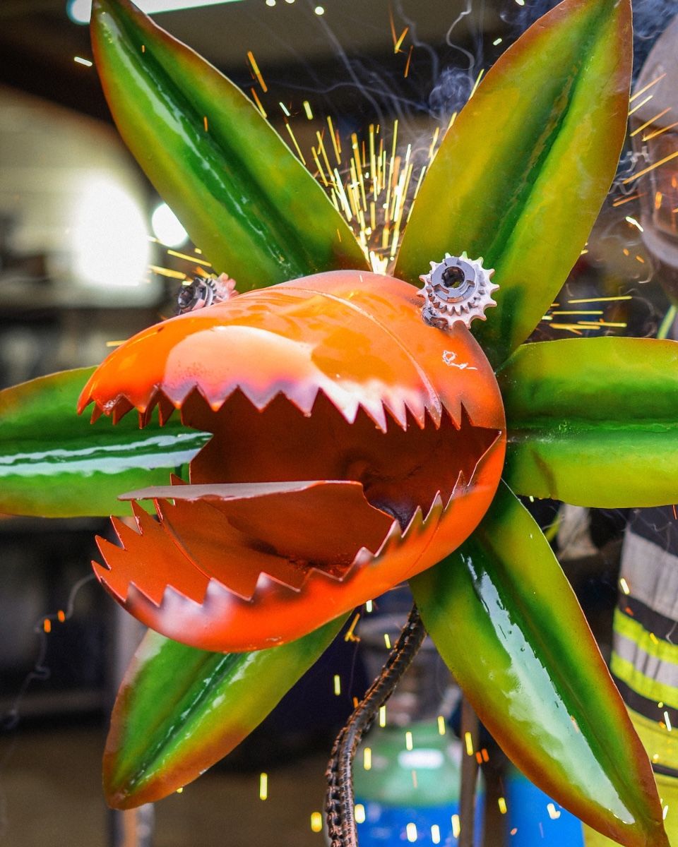 ‘Nibbler’ the Upcycled Metal Flower Garden Sculpture close up shot with sparks