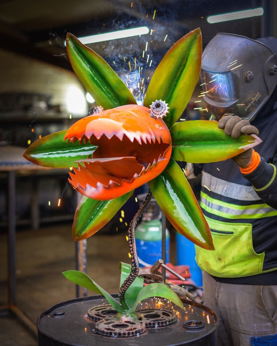 ‘Nibbler’ the Upcycled Metal Flower Garden Sculpture main image with welding sparks