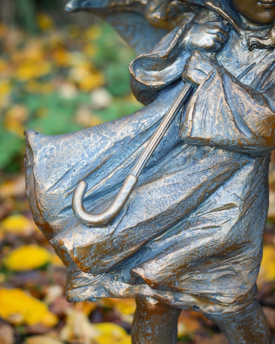 "Rain or Shine" Girl with Umbrella Resin Garden Sculpture Brass and Verdigris Finish close up of dress and umbrella handle