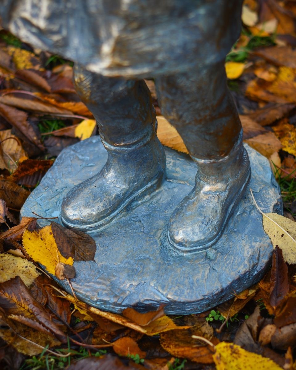 "Rain or Shine" Male Resin Garden Sculpture Brass and Verdigris Finish close up of base