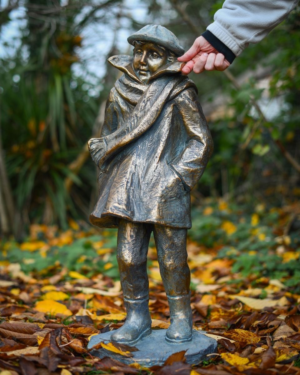 "Rain or Shine" Male Resin Garden Sculpture Brass and Verdigris Finish with hand in shot for scale