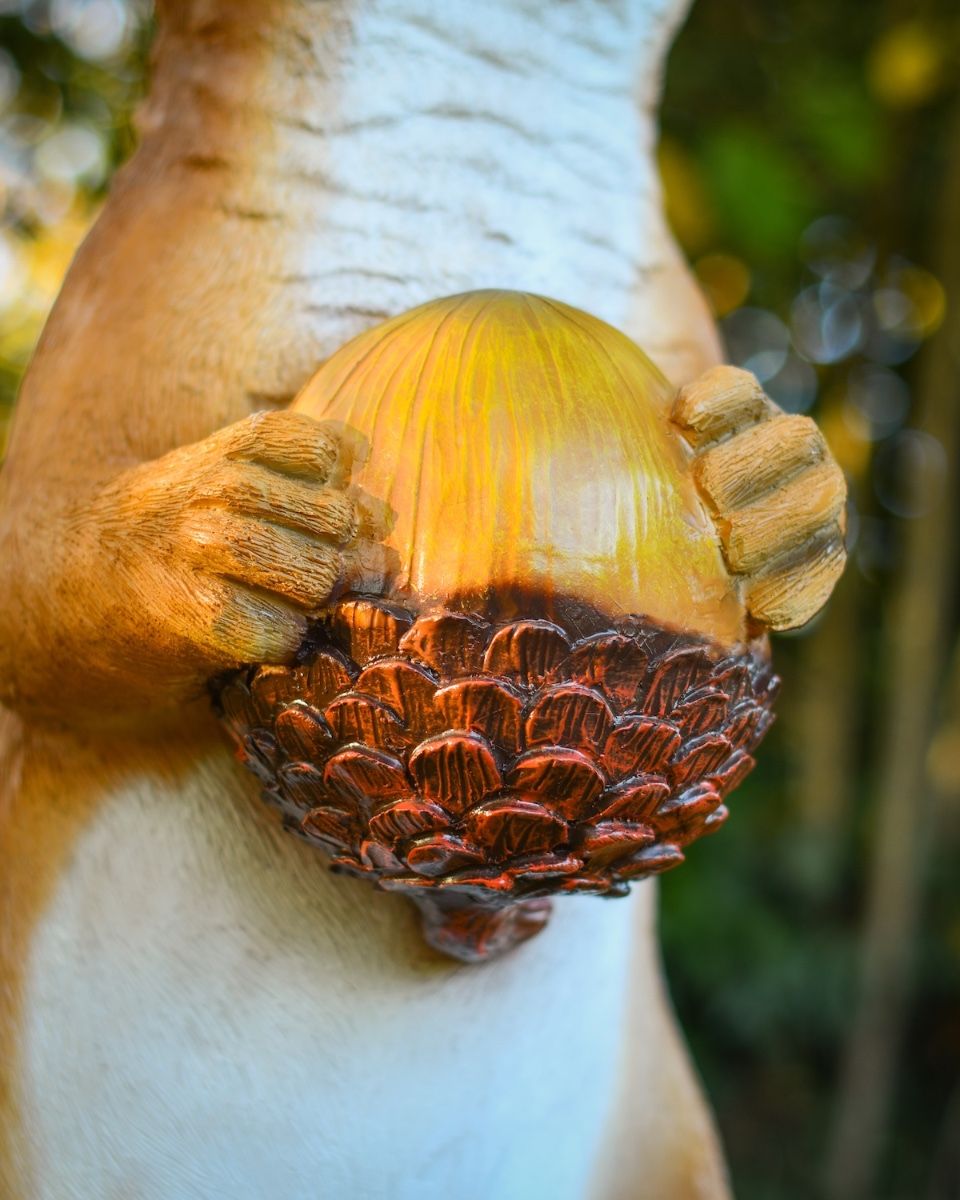 "Scoot" the Handpainted Fibreglass Squirrel Garden Sculpture close up of acorn