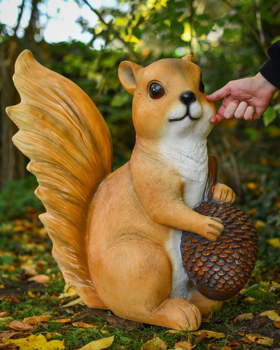 "Scurry" the Handpainted Fibreglass Squirrel Garden Sculpture with hand in shot for scale