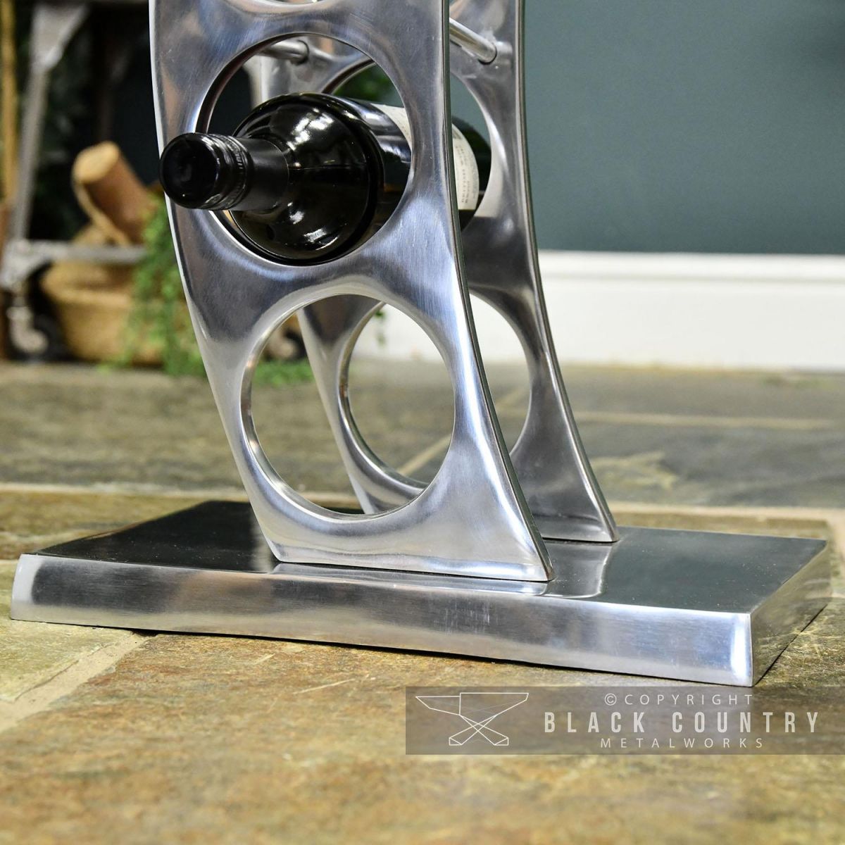 Close-up of the Rectangular Base on the “Serena” Aluminium Curved Wine and Bottle Holder