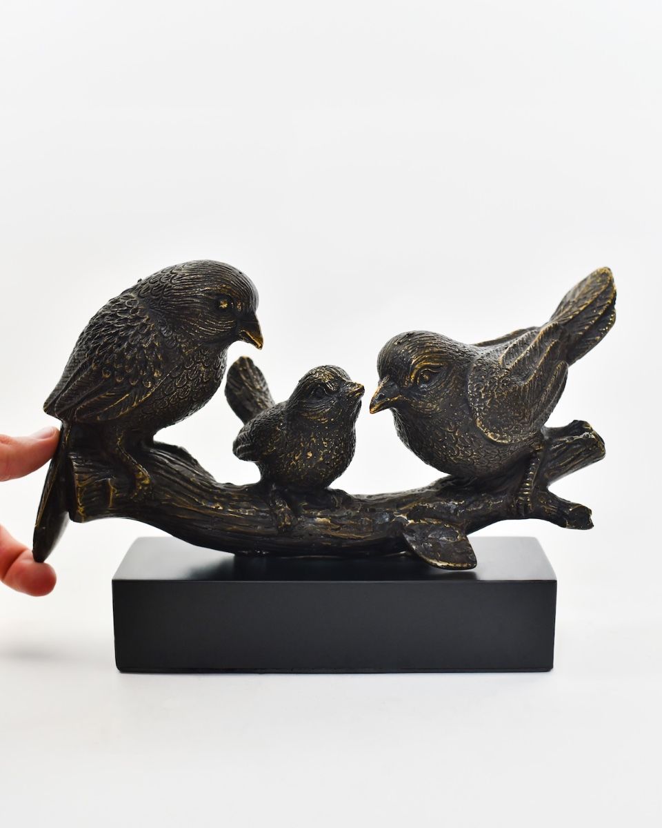 "Shadowed Songbirds" Cast Brass Ornament with hand in shot for scale