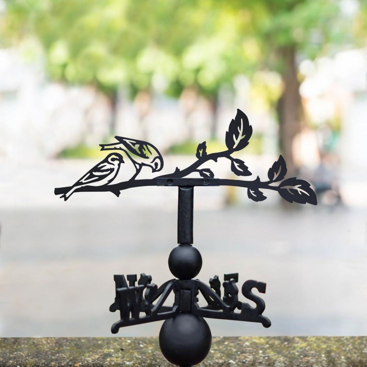 Siskin weathervane in the park Siskin weathervane in the park