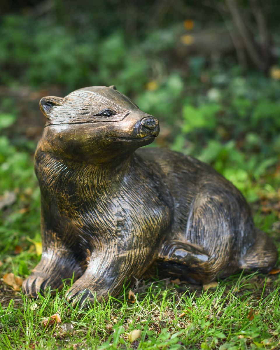 Angled view of badger face detail on gold garden sculpture
