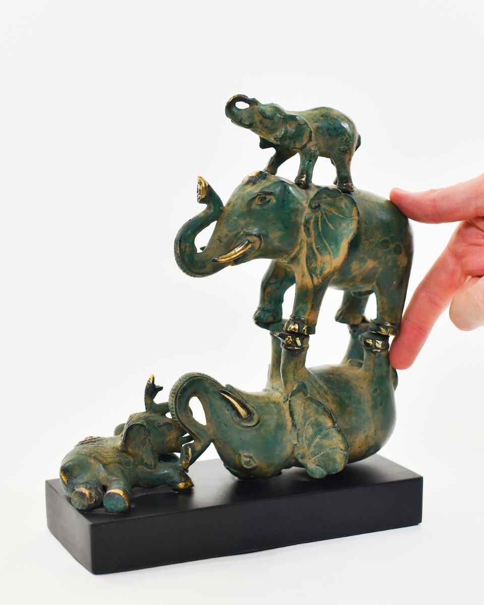 ‘The Pachyderm Pagoda" Cast Brass Elephant Ornament with hand in shot for scale