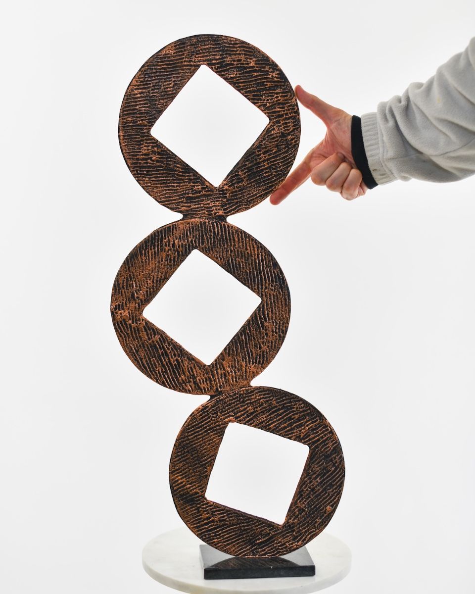 "Triple Aspect" Cast Aluminium Home Ornament - Copper with hand in shot for scale
