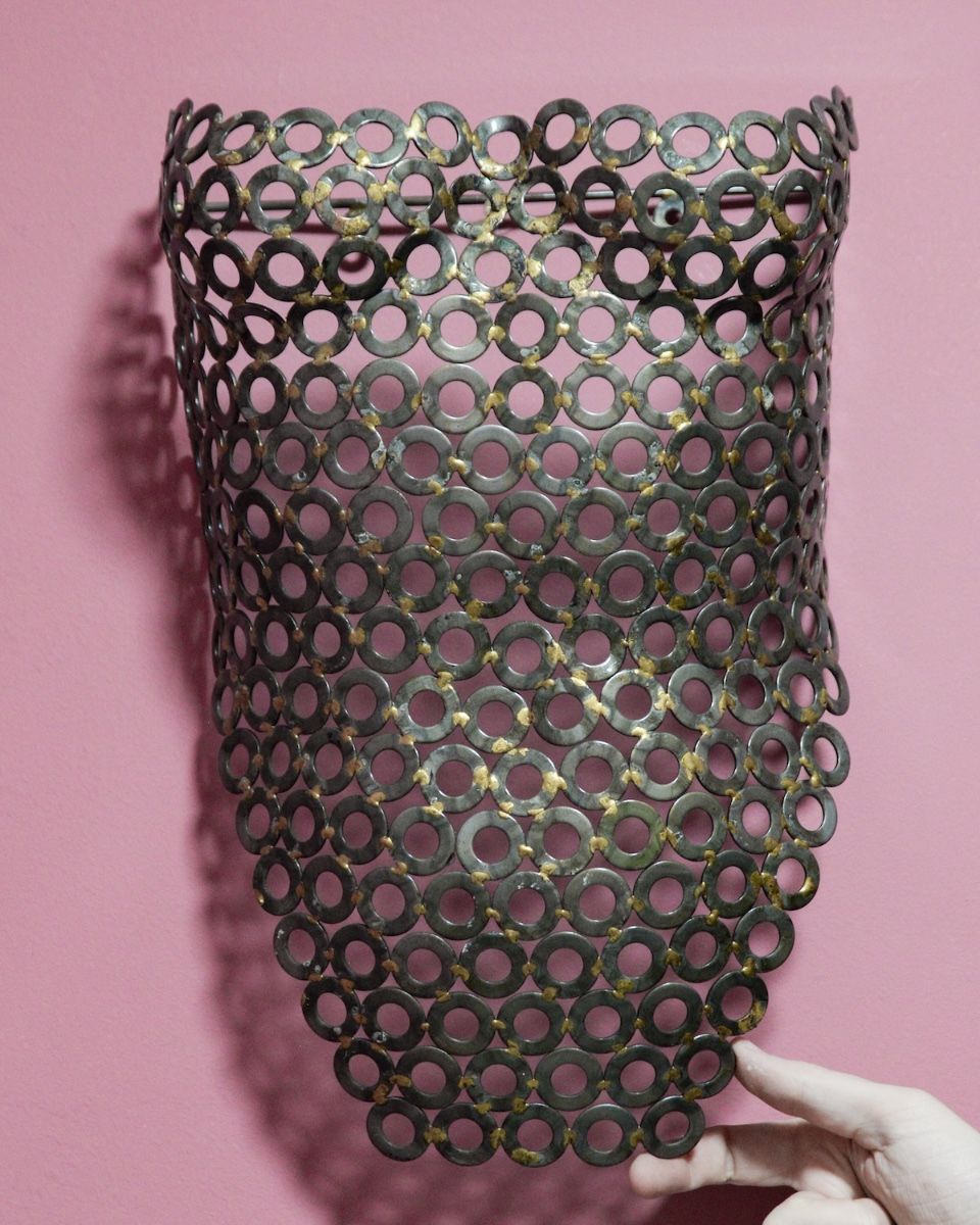 "Vesta" Female Torso Reclaimed Metal Wall Sculpture - 63cm mounted on wall close up with hand in shot for scale