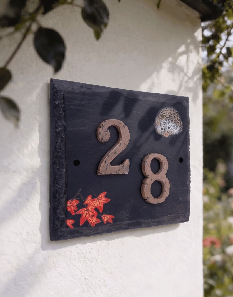 A "Helmsford House" Hedgehog Slate House Number Sign with a Number 28 Fixed to it Mounted on a White Cottage Wall - Digital Illustration