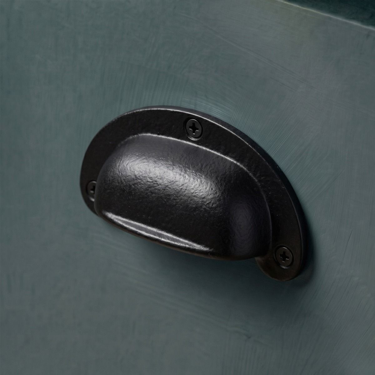 A Cast Iron Drawer Pull Shown Close up on a Blue Kitchen Drawer - Digital Illustration