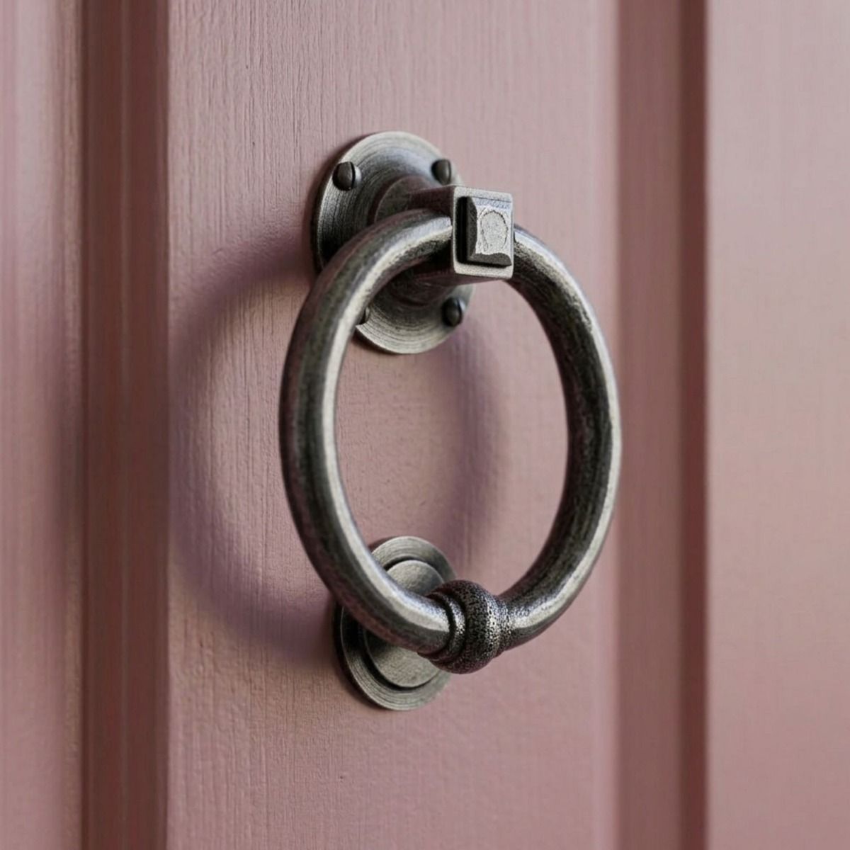 A Close up Image of the Slim Antique Pewter Ring Door Knocker on a Pink Door - Digital Illustration 
