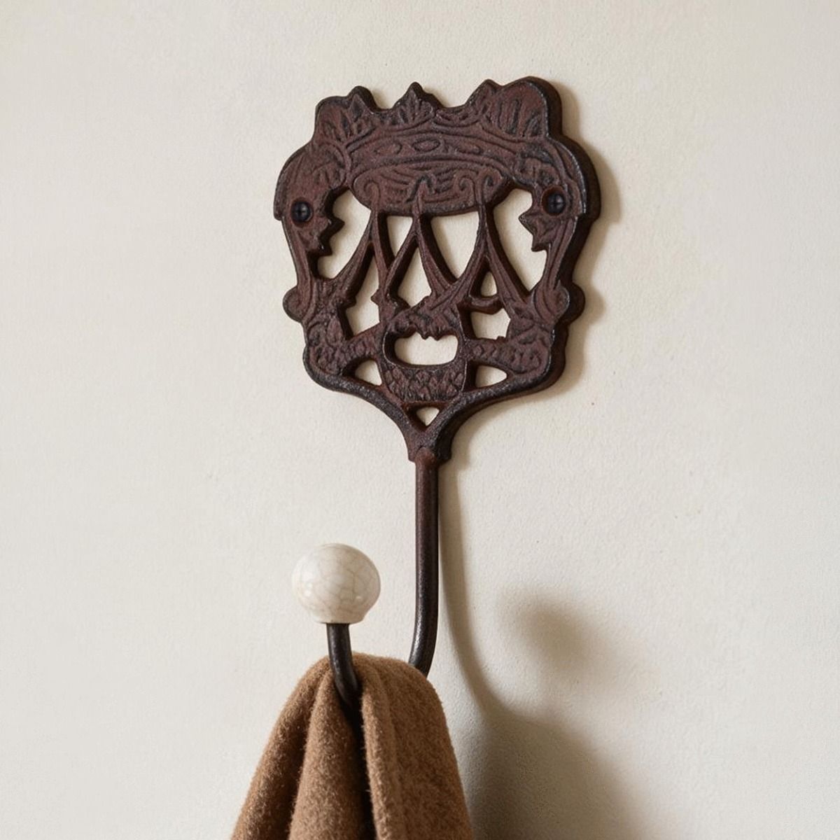 A Close up of the "Royal Camelot" Cast Iron Hook on a Wall in a traditional home - Digital Illustration 
