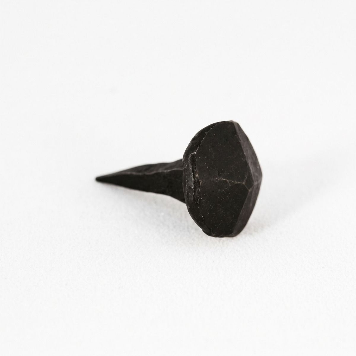 A close up of The Blacksmith door stud Shown on a White Background