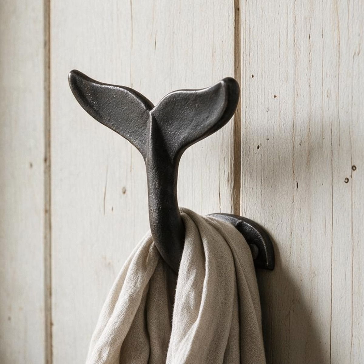 A Close up of the Whale Tail Cast Iron Coat & Hat Hook on a Wooden Wall in a Cosy Home - Digital Illustration 