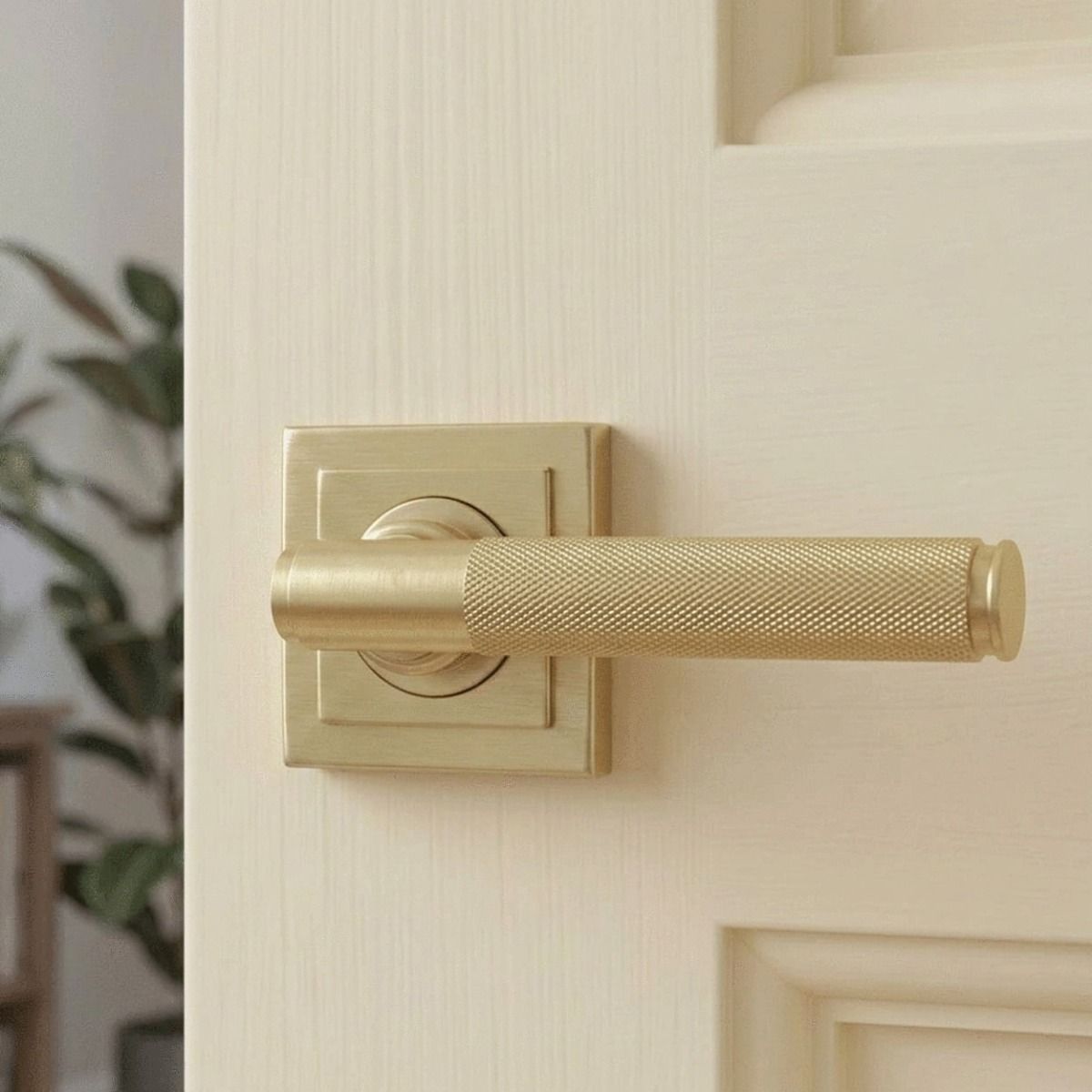 A Close up View of the Satin Brass "Royale" Square Concealed Door Handle on Rose Set on a Classic Cream Coloured Door in a Modern Home - Digital Illustration 