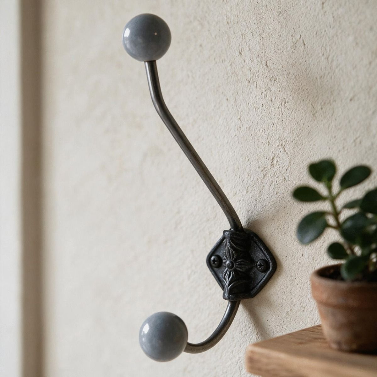 A Deep Grey Ceramic Tip Large Iron Coat Hook in a Corridor Entrance next to a Shelf - Digital Illustration 