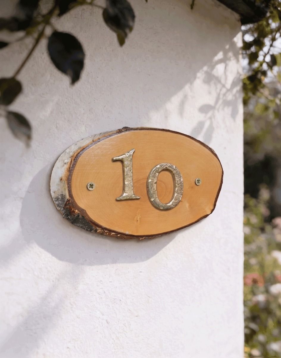 A Number 10 Natural Hard Wood Rustic House Number Sign Mounted on a Sunny White Garden Wall - Digital Illustration 