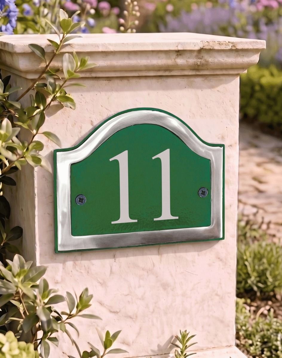 A Number 11in Vinyl Green & Chrome Arched House Number Sign Mounted on an Entrance Driveway Wall - Digital Illustration