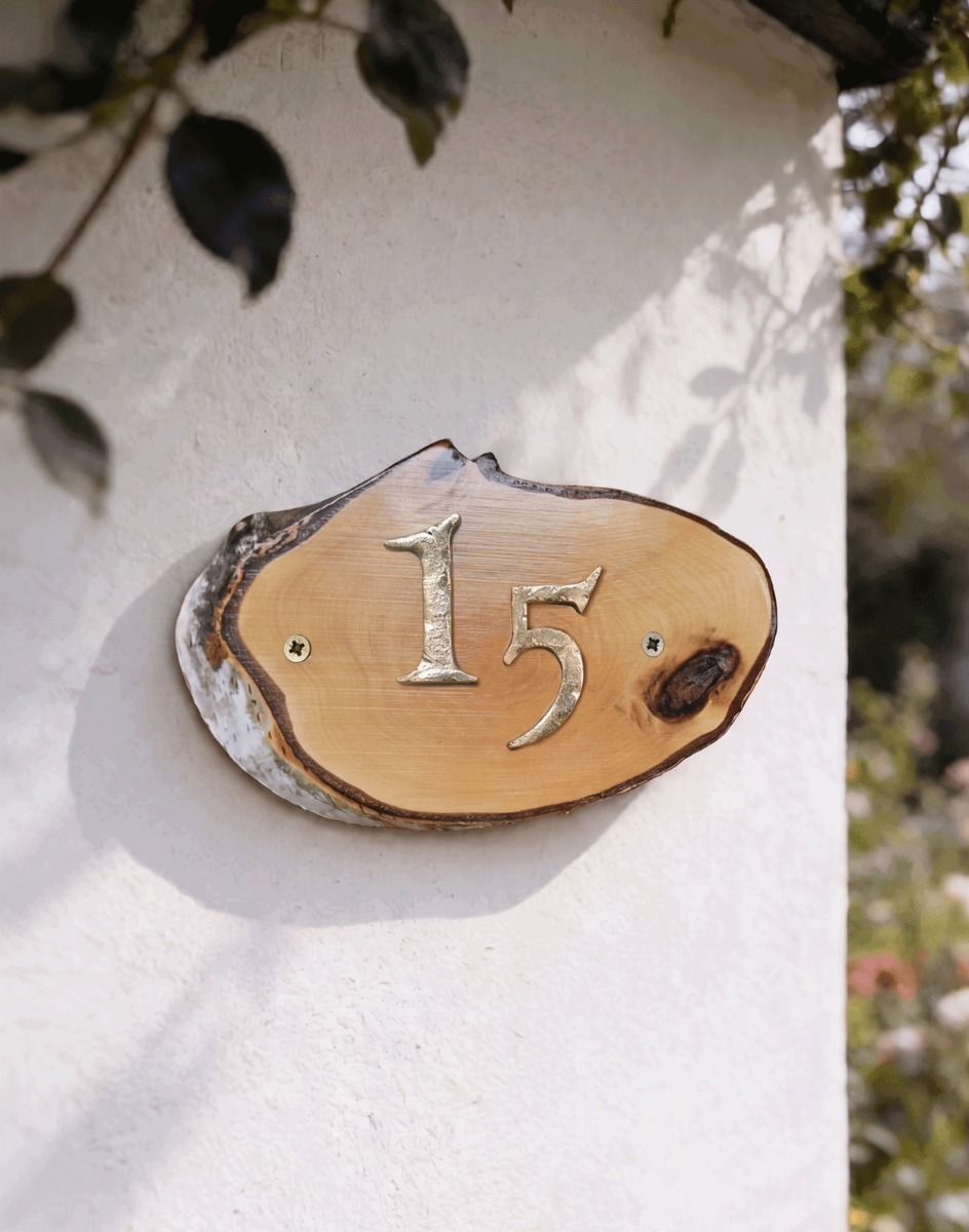 A Number 15 Natural Hard Wood Rustic House Number Sign Mounted on a Sunny Cottage Wall - Digital Illustration 
