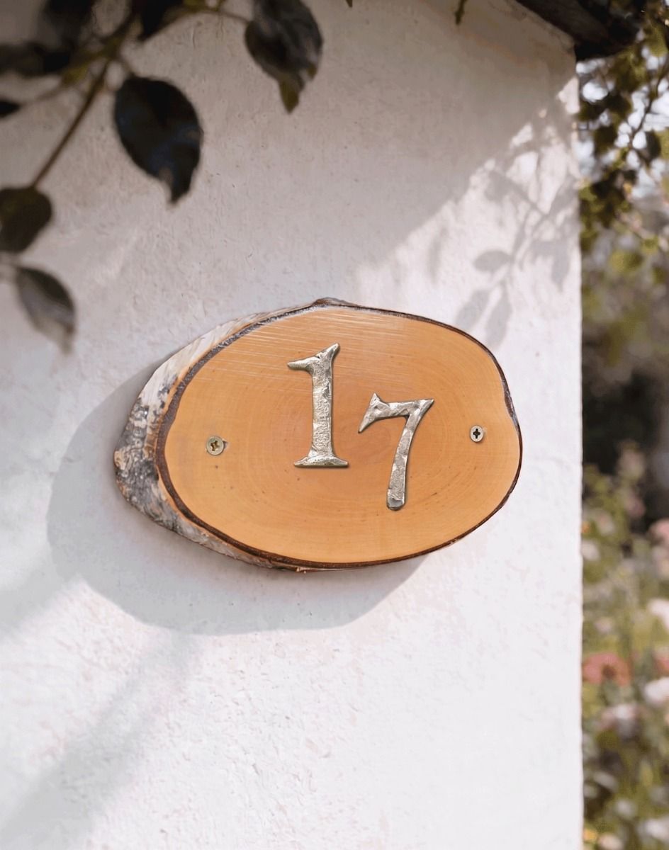 A Number 17 Natural Hard Wood Rustic House Number Sign Mounted on a Sunny Cottage Garden Wall - Digital Illustration
