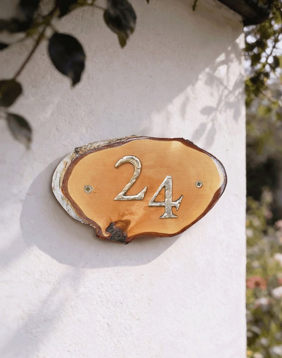 A Number 24 Natural Hard Wood Rustic House Number Sign Mounted on a Sunny White Garden Wall - Digital Illustration