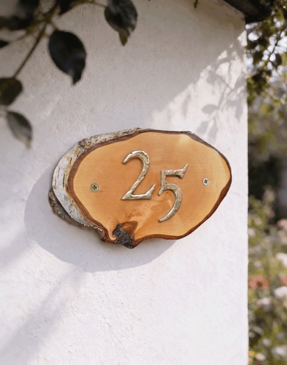 A Number 25 Natural Hard Wood Rustic House Number Sign Mounted on a Sunny Garden Cottage Wall - Digital Illustration 